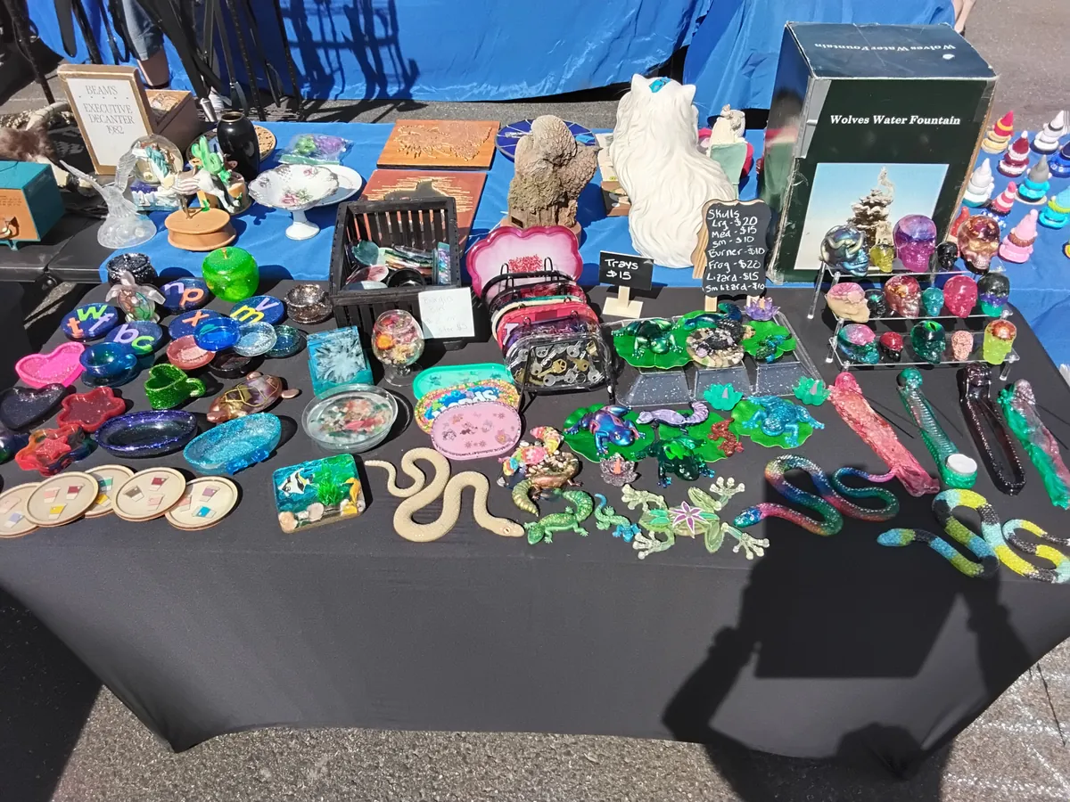 Table of resin snakes, skulls, frogs, and glitter coasters