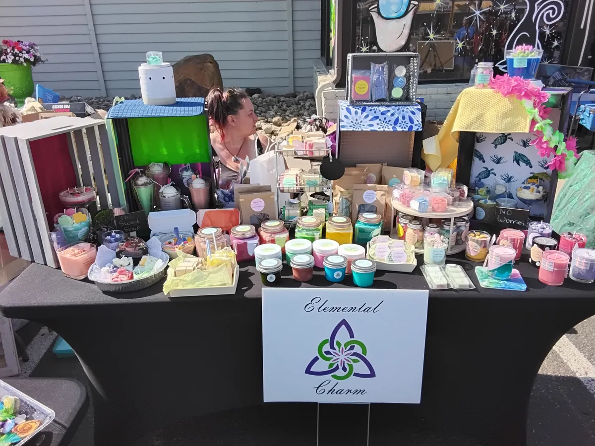 Elemental Charm market stall stacked with candles, soaps, and jars